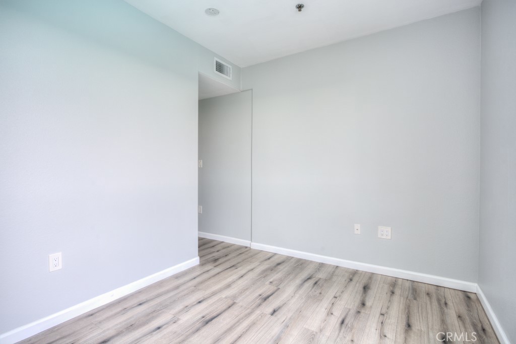 580 West Main Street, Unit 302 Alhambra, CA 91801 - Photo 29 of 41 a view of an empty room with wooden floor