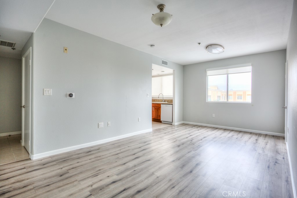580 West Main Street, Unit 302 Alhambra, CA 91801 - Photo 7 of 41 an empty room with wooden floor and windows