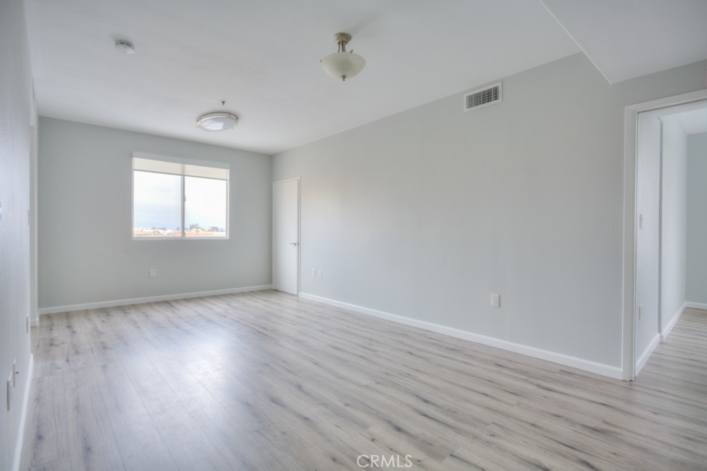 580 West Main Street, Unit 302 Alhambra, CA 91801 - Photo 8 of 41 an empty room with wooden floor and windows