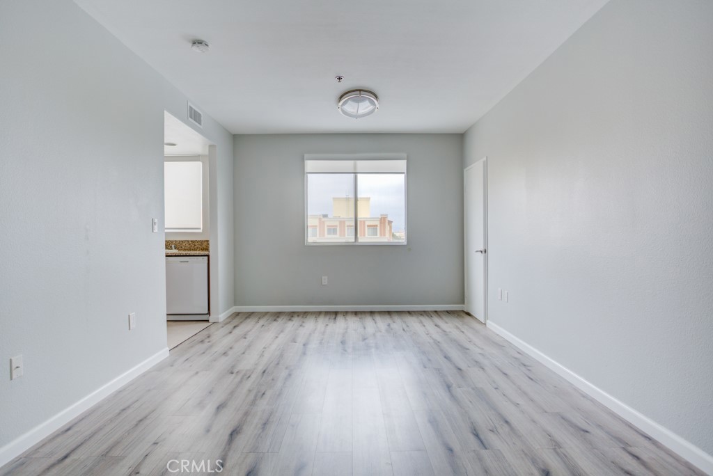 580 West Main Street, Unit 302 Alhambra, CA 91801 - Photo 10 of 41 an empty room with wooden floor and windows