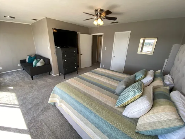 a bed sitting in a bedroom next to a large window