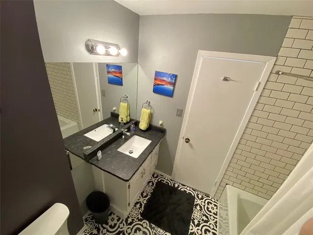 a bathroom with a toilet sink and mirror