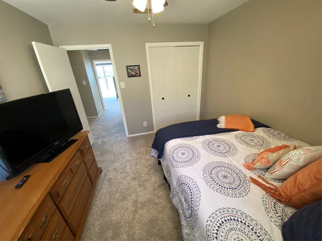 a bedroom with a bed and a television