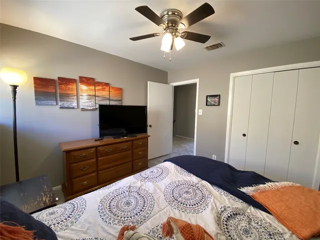 a bed sitting in a bedroom next to a window