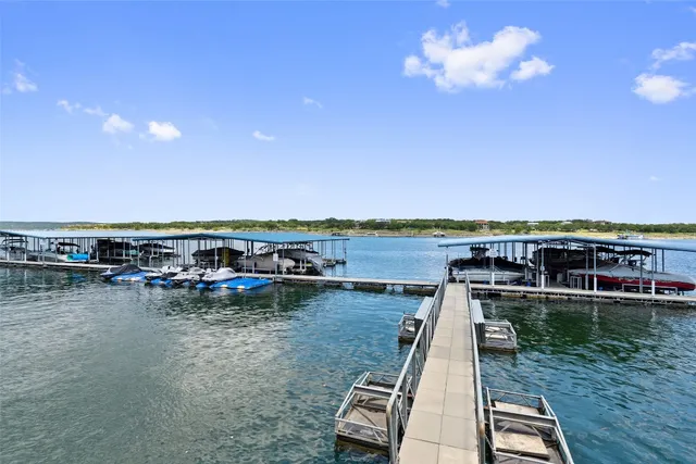 a view of a lake with a table and chairs