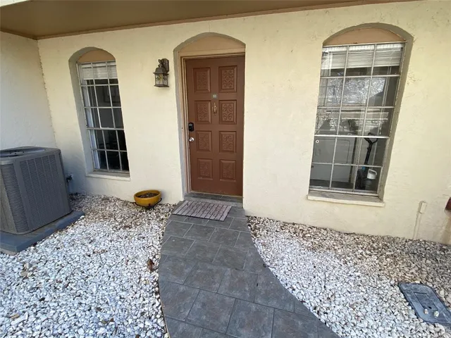 a dining room with furniture and a floor to ceiling window