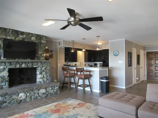 a kitchen with granite countertop a sink a stove and refrigerator
