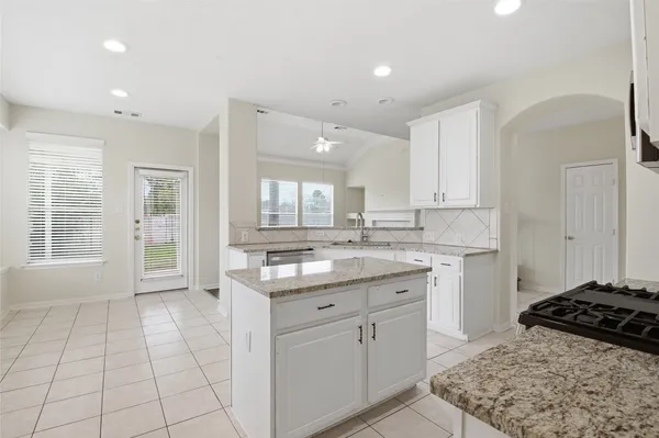 a kitchen with a sink stove and cabinets