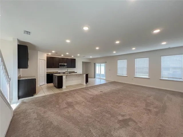 a view of kitchen with refrigerator and window