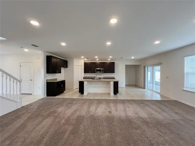 a view of kitchen with microwave oven stove and cabinets
