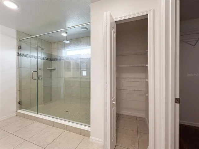 a bathroom with a glass shower door