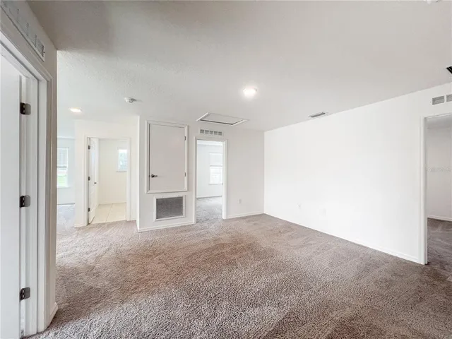 a view of an empty room with a fireplace