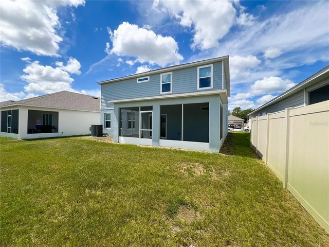 a view of a house with a backyard