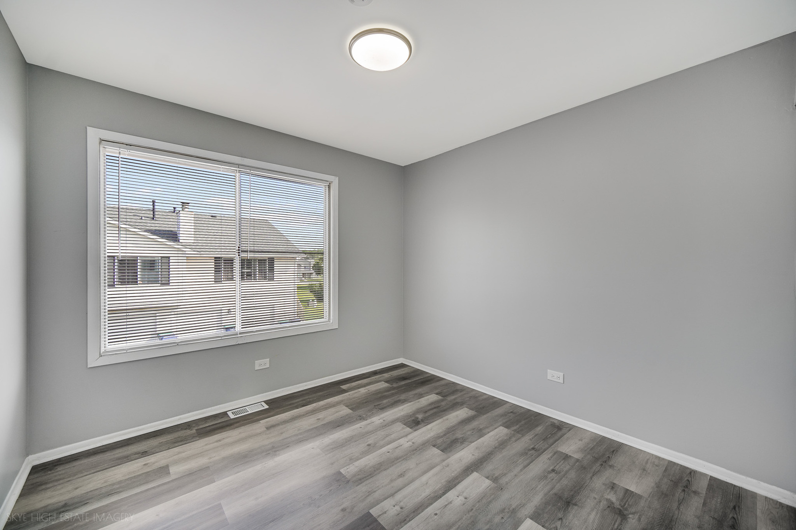 103 Red Barn Road, Unit 103 Matteson, IL 60443 - Photo 15 of 17 an empty room with wooden floor and windows