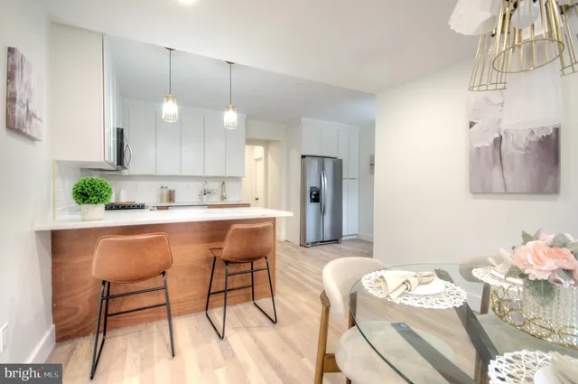 a kitchen with granite countertop white cabinets and stainless steel appliances