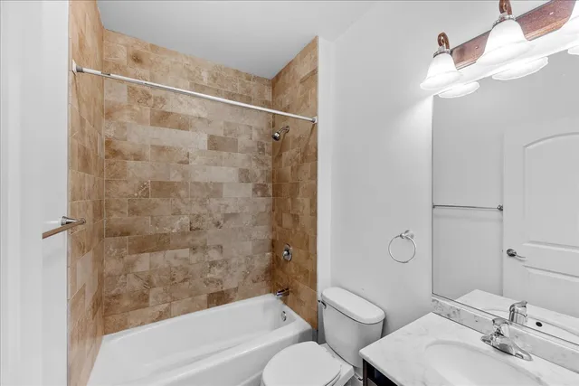 a bathroom with a toilet sink and shower
