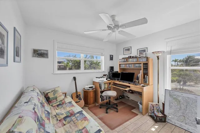 a view of a livingroom with workspace and a window