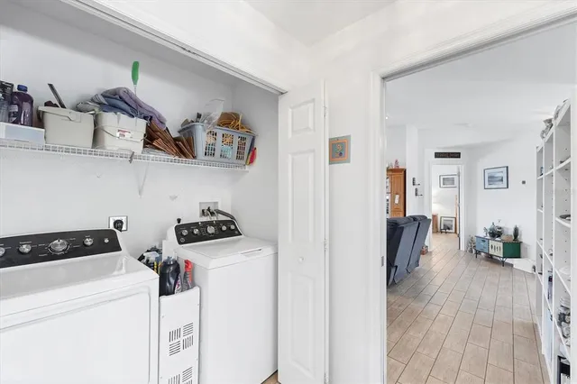a view of a kitchen with fridge and workspace