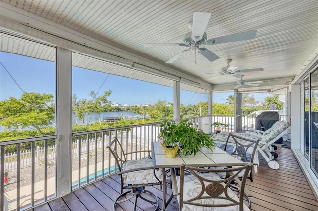 a view of a balcony with furniture and wooden floor
