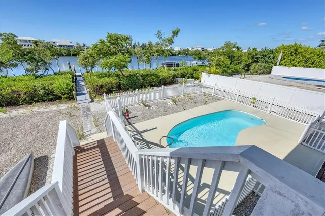 a view of a balcony with two chairs and a table