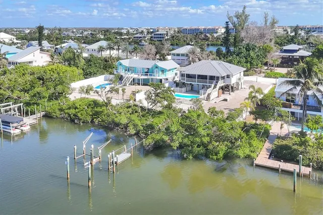 an aerial view of a house with a lake view