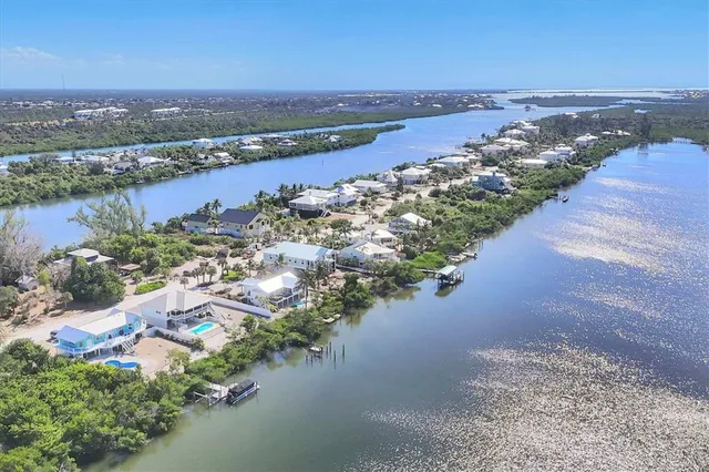 an aerial view of a houses with ocean view