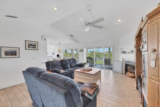 a living room with furniture fireplace and a large window