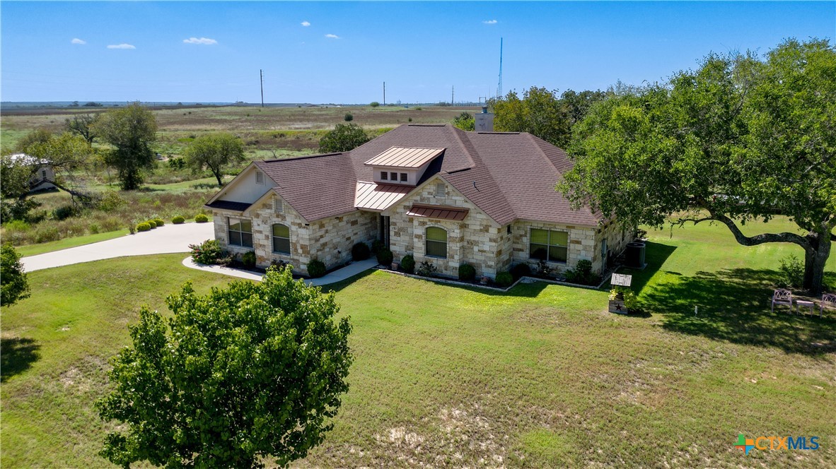 an aerial view of a house with garden space and street view