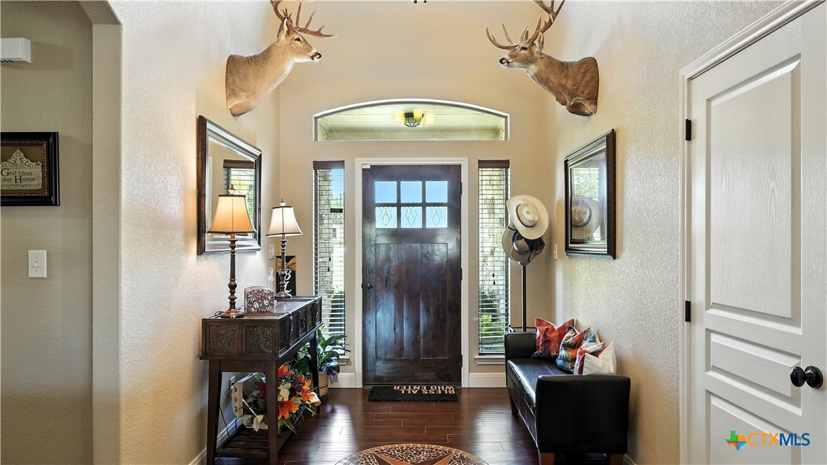 121 Carrizo Ridge Floresville, TX 78114 - Photo 11 of 43 a front view of a house with entryway and wooden floor
