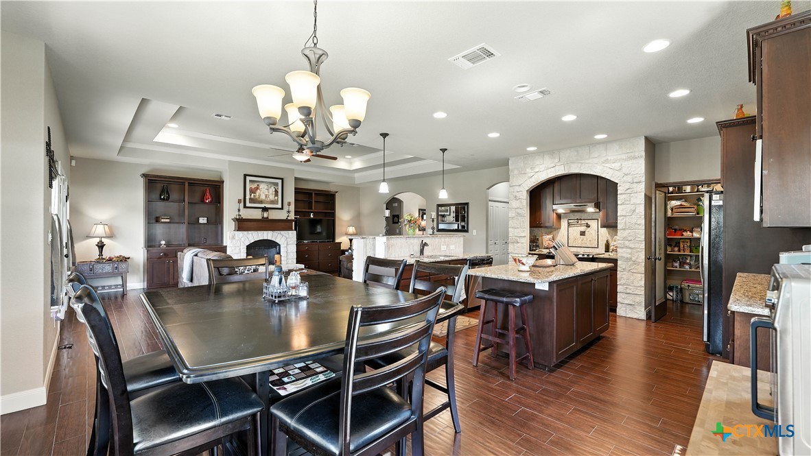 121 Carrizo Ridge Floresville, TX 78114 - Photo 21 of 43 a view of a dining room and livingroom with furniture wooden floor a chandelier