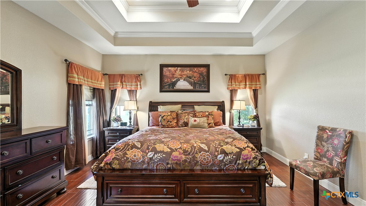 121 Carrizo Ridge Floresville, TX 78114 - Photo 24 of 43 a bedroom with a bed and wooden floor