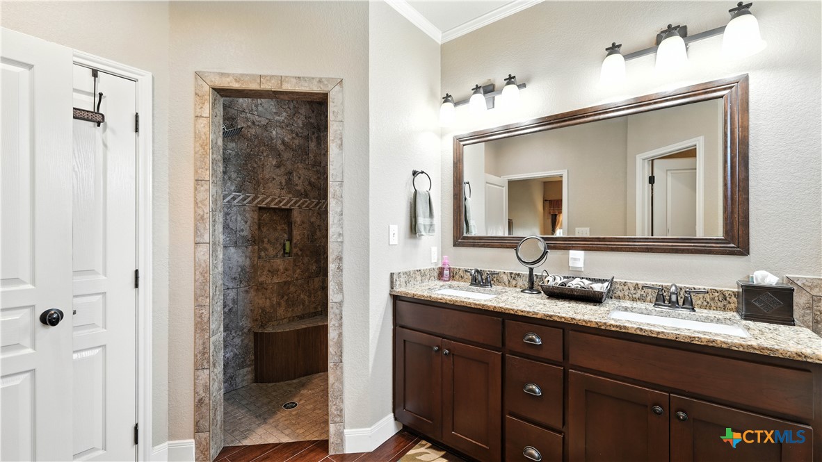 121 Carrizo Ridge Floresville, TX 78114 - Photo 26 of 43 a bathroom with a double vanity sink and a mirror