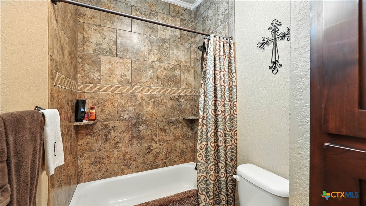 121 Carrizo Ridge Floresville, TX 78114 - Photo 34 of 43 a bathroom with a shower and a toilet