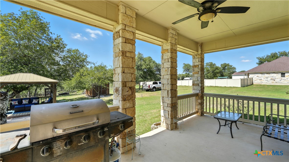 121 Carrizo Ridge Floresville, TX 78114 - Photo 8 of 43 a view of a patio with a table chairs and a patio