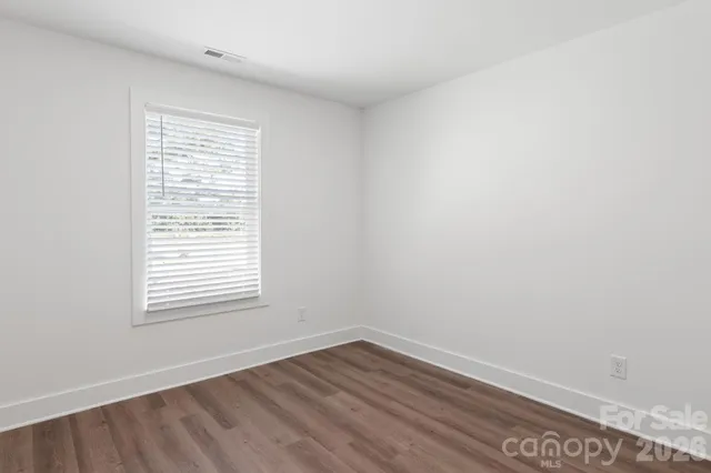 a bathroom with a granite countertop sink a toilet and a mirror