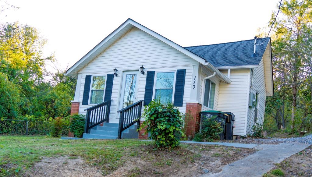 113 Jackson Street Northeast Rome, GA 30161 - Photo 1 of 1 a view of a house with a yard and plants
