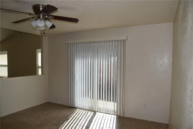 a view of a livingroom with a chandelier fan