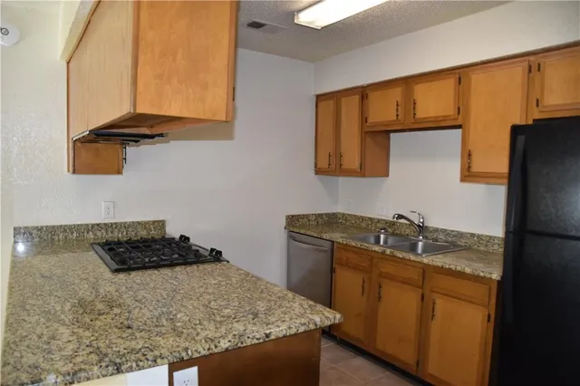 a kitchen with a sink stove and refrigerator