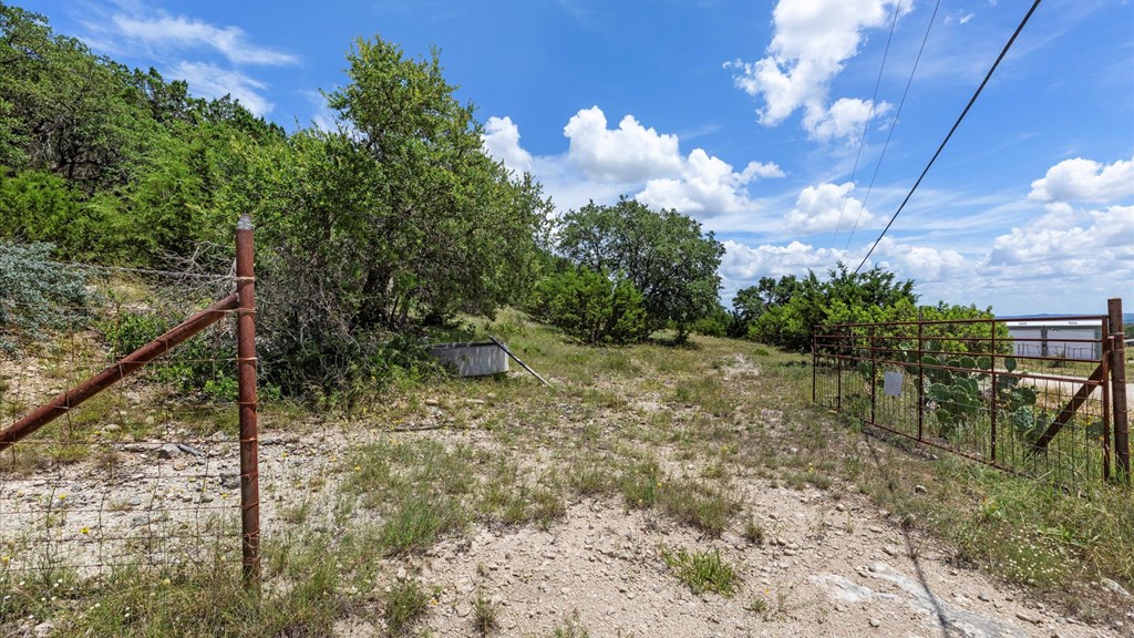 Undisclosed Address Spring Branch, TX 78070 - Photo 3 of 15 a view of a yard with plants and a bench