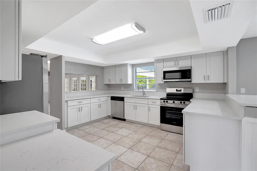 114 Barkfield Street Brandon, FL 33511 - Photo 15 of 59 a kitchen with a stove a sink and a refrigerator