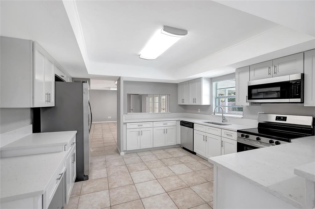 114 Barkfield Street Brandon, FL 33511 - Photo 16 of 59 a kitchen with a stove a sink and a refrigerator