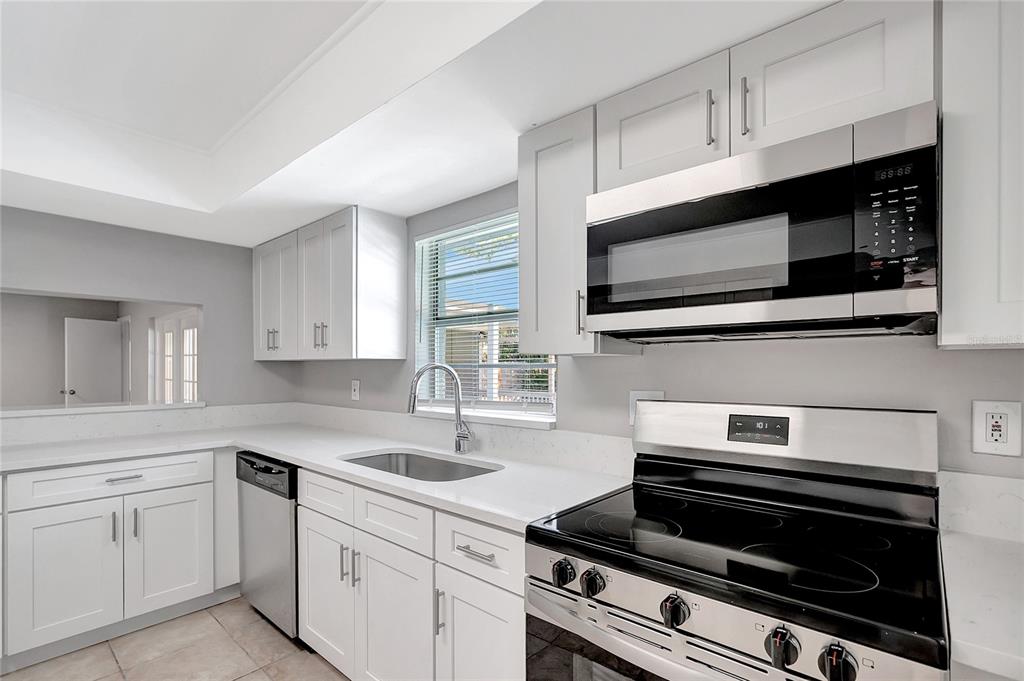 114 Barkfield Street Brandon, FL 33511 - Photo 17 of 59 a kitchen with cabinets stainless steel appliances and sink
