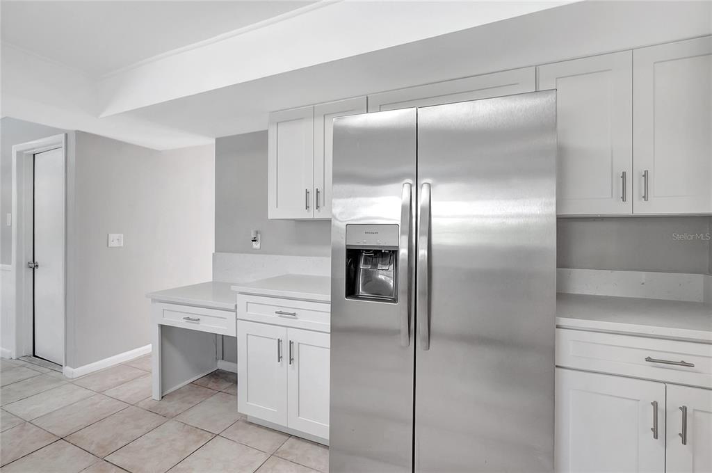 114 Barkfield Street Brandon, FL 33511 - Photo 19 of 59 a kitchen with a refrigerator and white cabinets