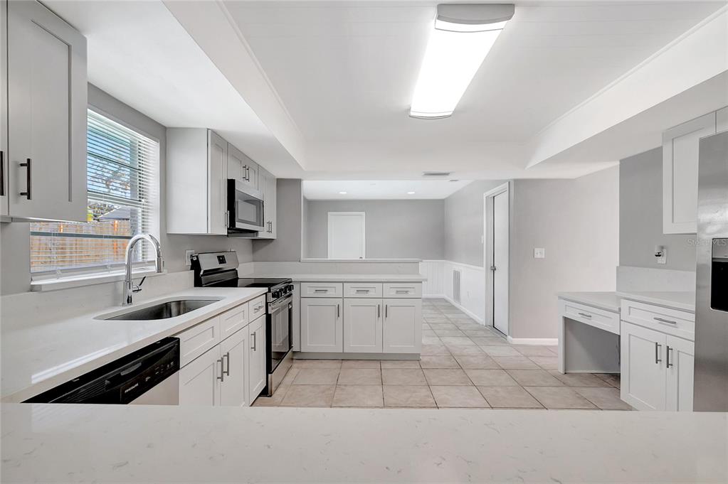 114 Barkfield Street Brandon, FL 33511 - Photo 21 of 59 a kitchen with a sink stove top oven and cabinets