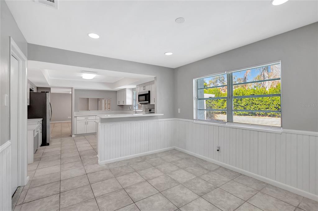 114 Barkfield Street Brandon, FL 33511 - Photo 26 of 59 a large white kitchen with a white cabinets and a window