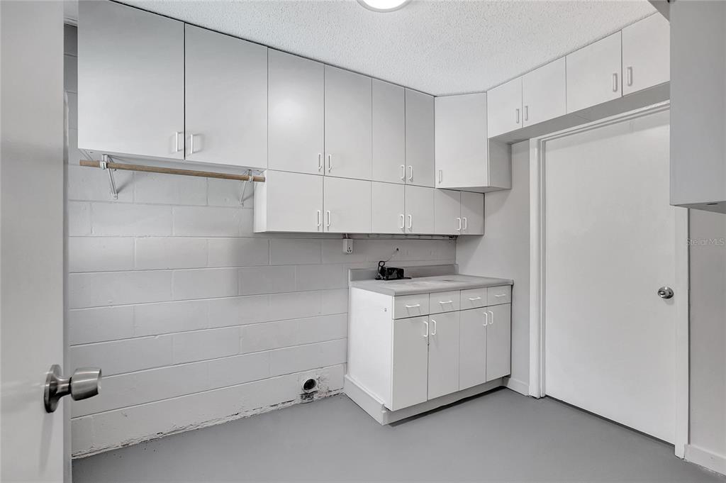114 Barkfield Street Brandon, FL 33511 - Photo 28 of 59 a utility room with cabinets washer and dryer