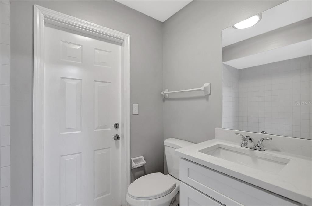 114 Barkfield Street Brandon, FL 33511 - Photo 36 of 59 a bathroom with a granite countertop toilet sink vanity and mirror