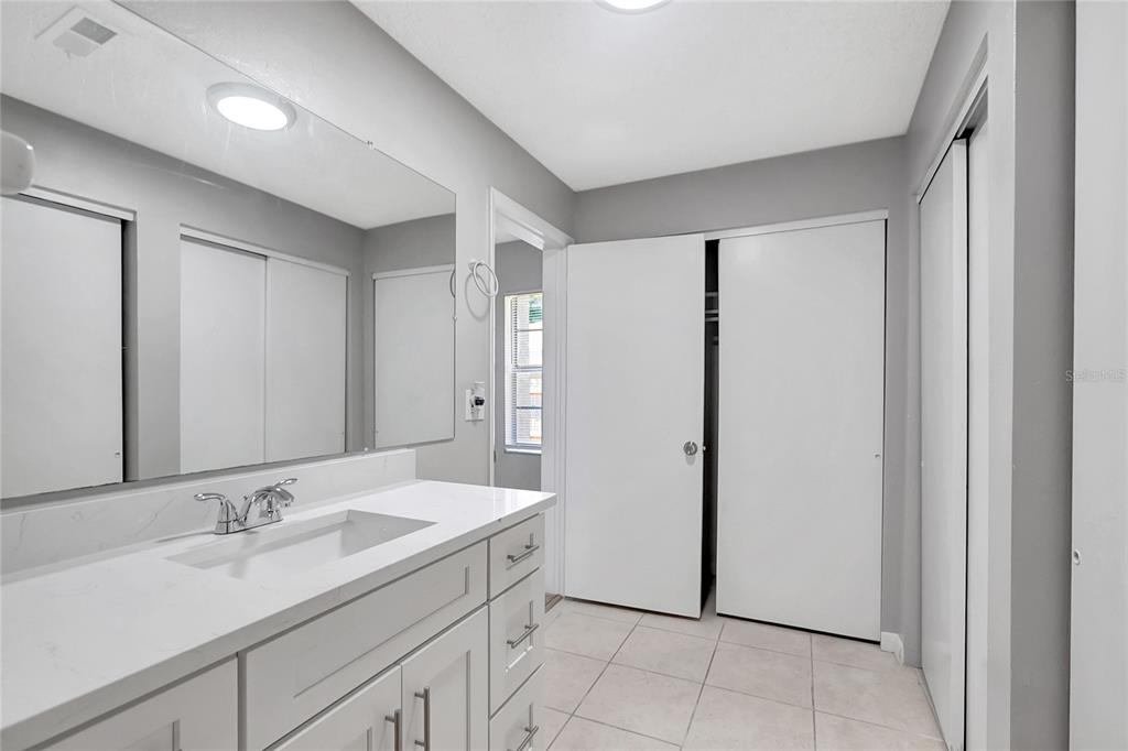 114 Barkfield Street Brandon, FL 33511 - Photo 37 of 59 a bathroom with a double vanity sink and mirror