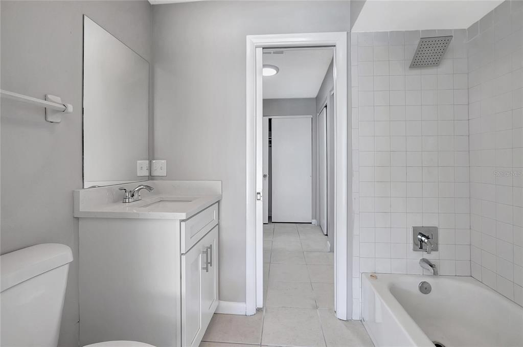 114 Barkfield Street Brandon, FL 33511 - Photo 38 of 59 a bathroom with a granite countertop sink a toilet and shower