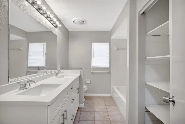 a view of a room with wooden floor and windows